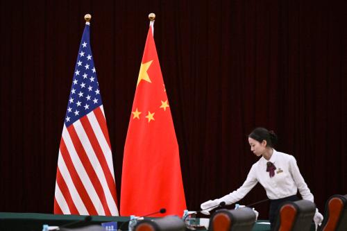 US flag, China flag, person arranging the table.