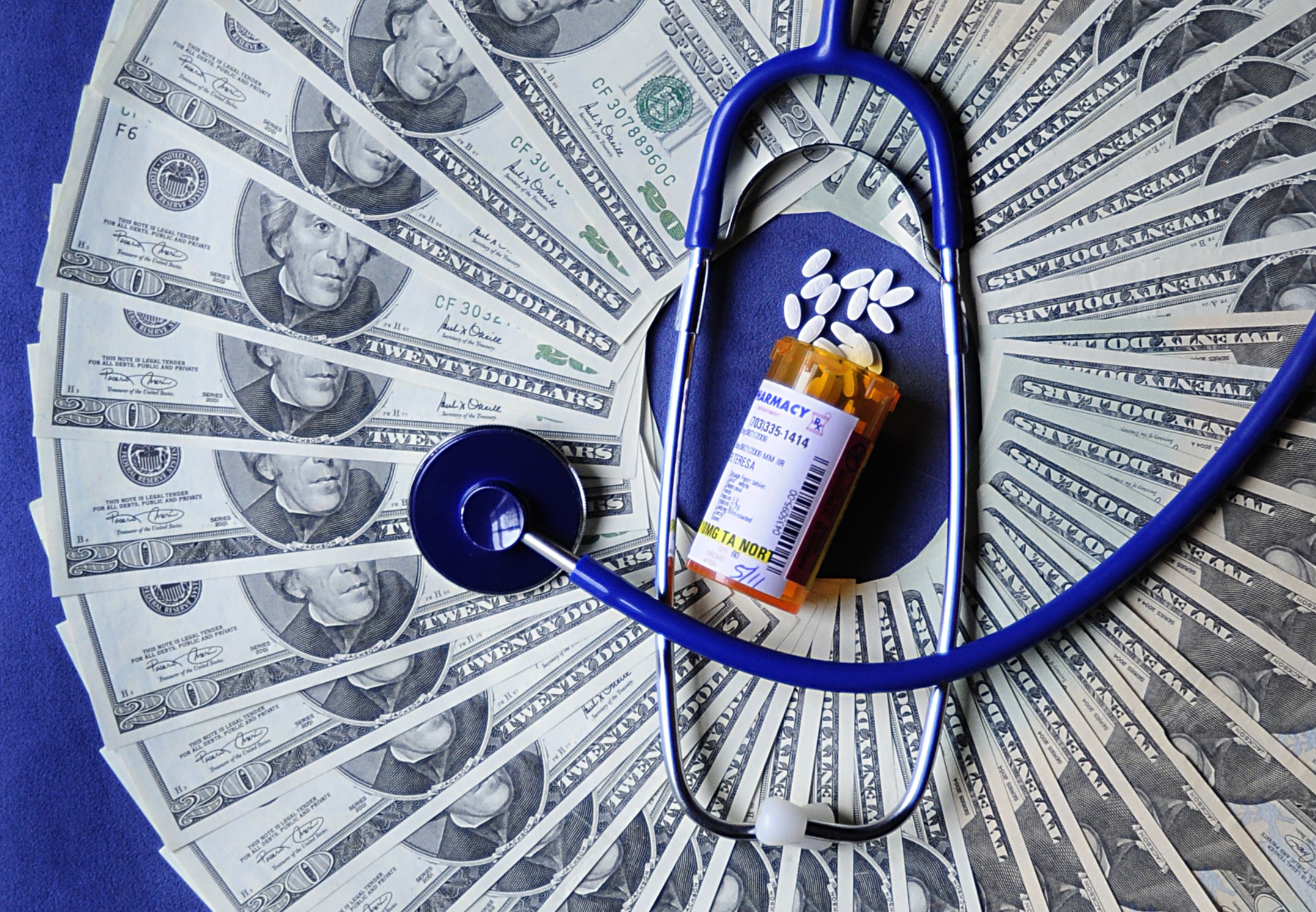 Dollar bills with medicine and stethoscope