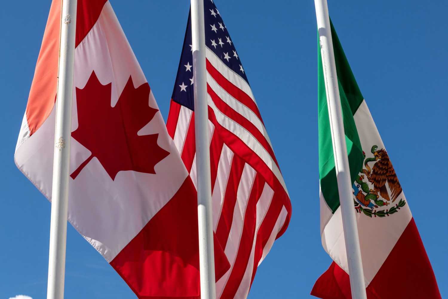 The flags of Canada, the United States, and Mexico