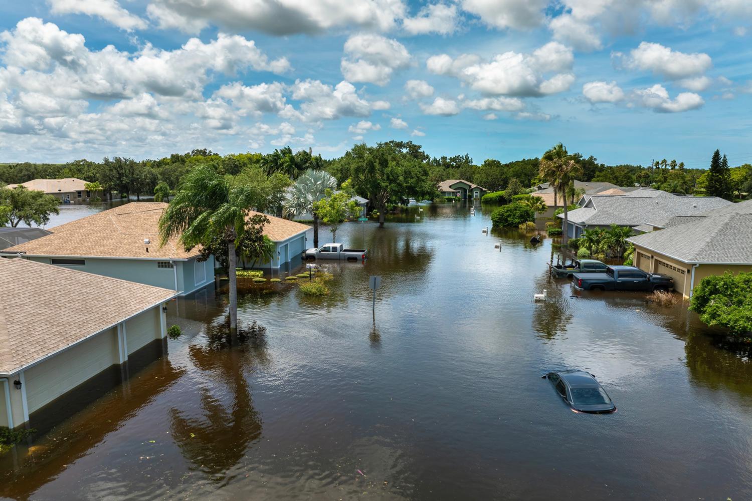 Flooded Florida street with stuck car after hurricane Debby rainfall surrounded with water. Consequences of natural disaster