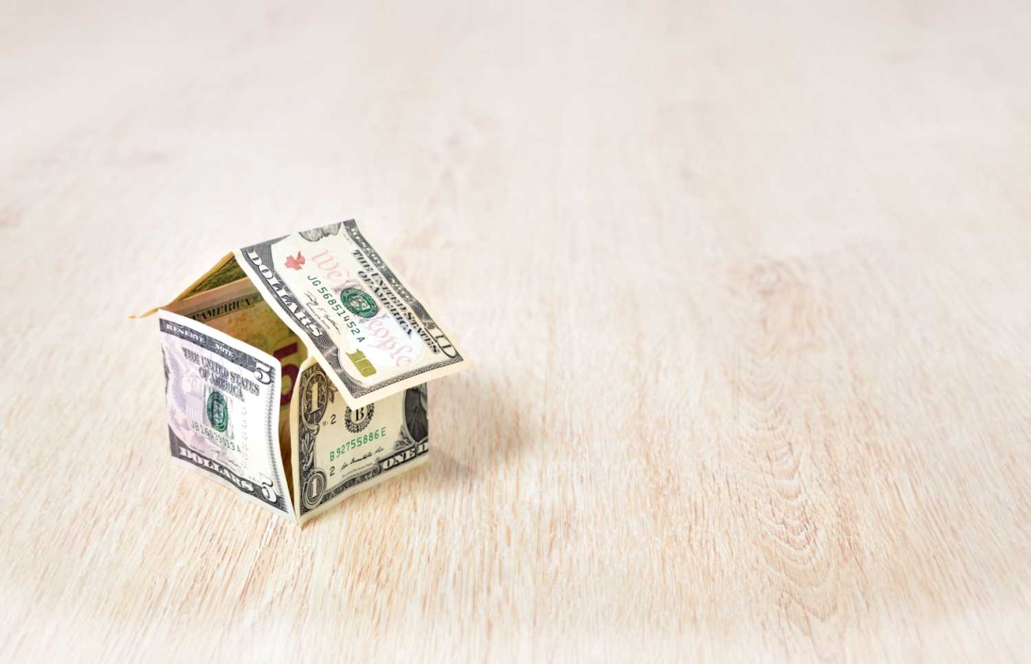 Small house made of folded dollar bills.