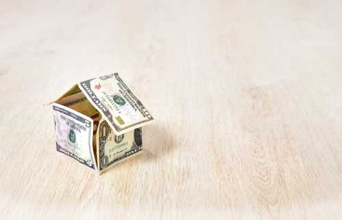 Small house made of folded dollar bills.