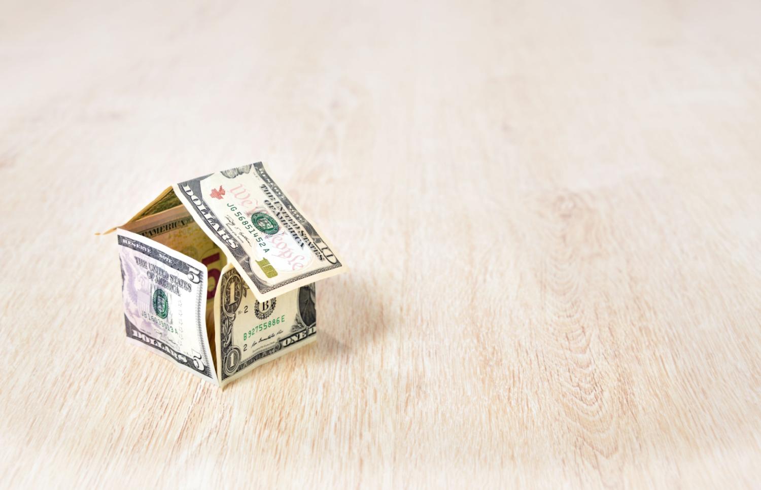 Small house made of folded dollar bills.