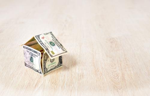 Small house made of folded dollar bills.