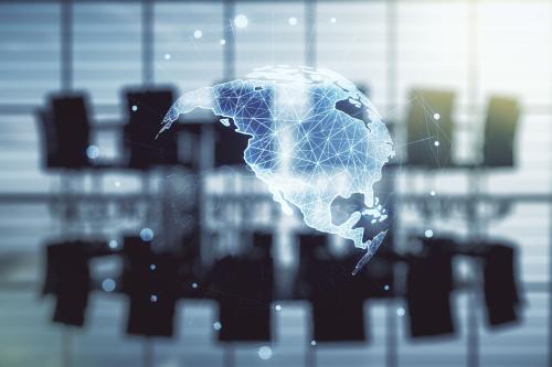 Map of North America superimposed over an out-of-focus photo of a conference room
