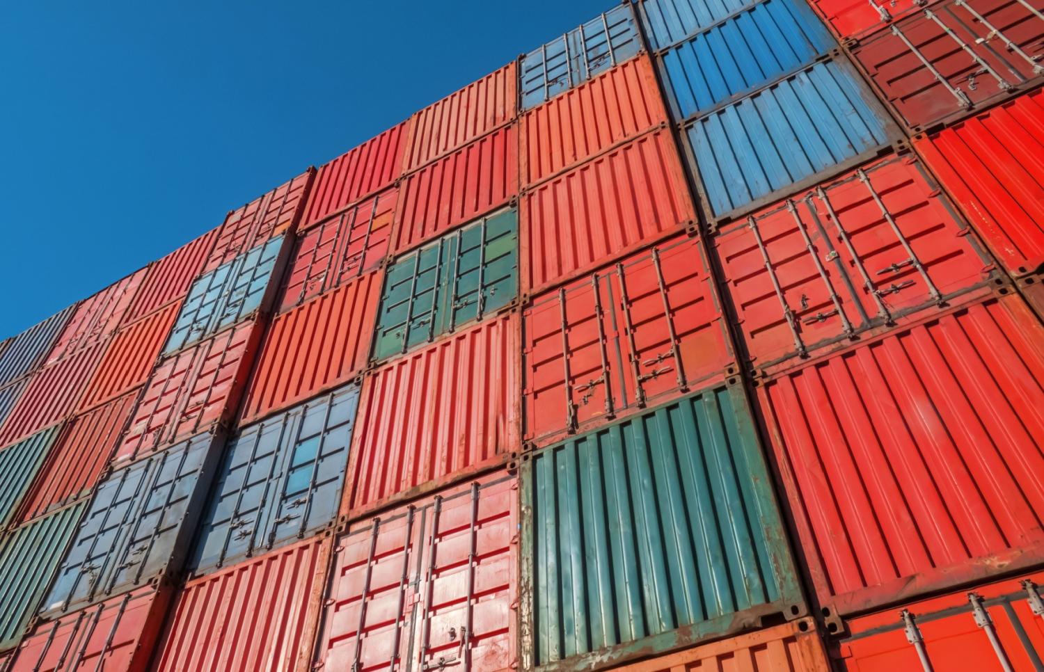 Tall stack of shipping containers.