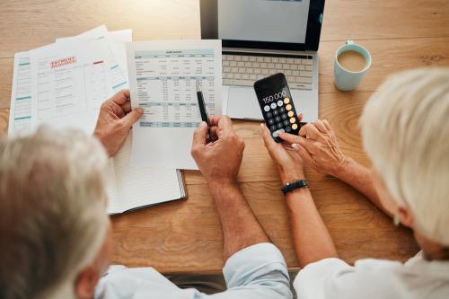 Older couple looking at budget paperwork.