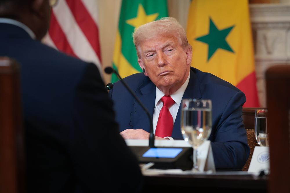 President Trump listens to speakers at a luncheon at the White House