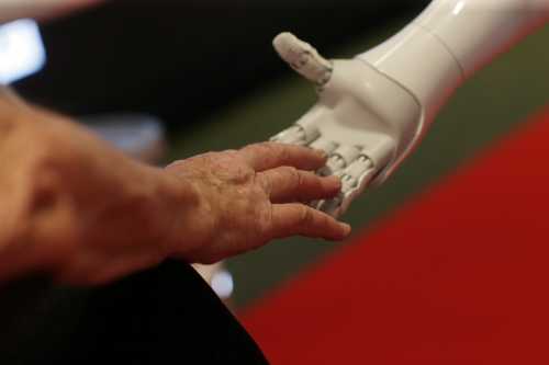 GENEVA, SWITZERLAND — JULY 7: Robot Pepper meets an elderly woman on July 7, 2023, in Geneva, Switzerland. Some 3,000 global experts from Big Tech, education, and international organizations gathered at a two-day summit in Geneva organized by the United Nations to discuss artificial intelligence and its potential for empowering humanity.