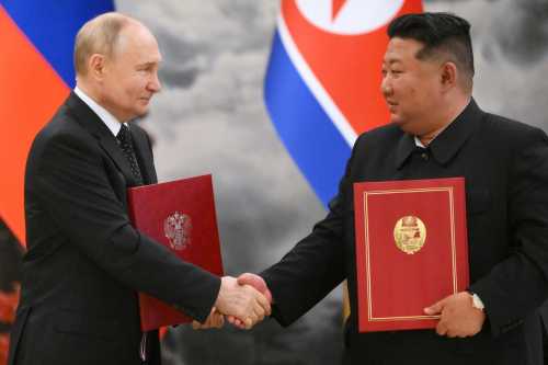 In this pool photograph distributed by the Russian state agency Sputnik, Russian President Vladimir Putin (L) shakes hands with North Korea's leader Kim Jong Un (R) after a signing ceremony following their bilateral talks at Kumsusan state residence in Pyongyang, on June 19, 2024.