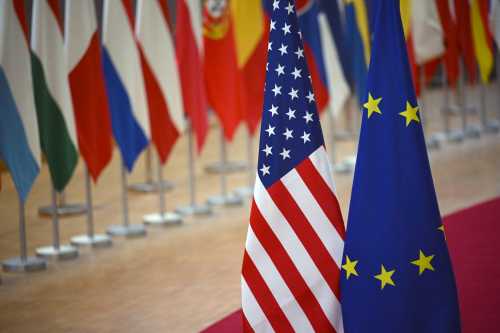 A European Union flag (R) and a US' national flag are displayed at the end of a EU Foreign Affairs Council about Trade in Brussels on November 24, 2025.