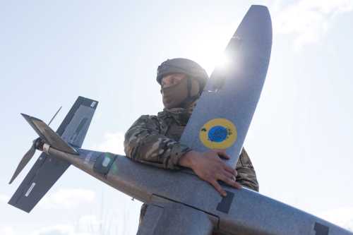 A portrait of a soldier from the "Taifun" unmanned aerial vehicle unit holding a new model 'Marsianin' attack drone on April 7, 2026 in Kharkiv region, Ukraine.