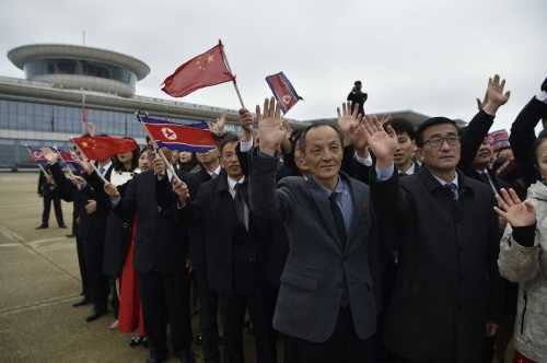 Well-wishers welcome Chinese Foreign Minister Wang Yi (not pictured) as he arrives on a two-day visit at Pyongyang International Airport on April 9, 2026.