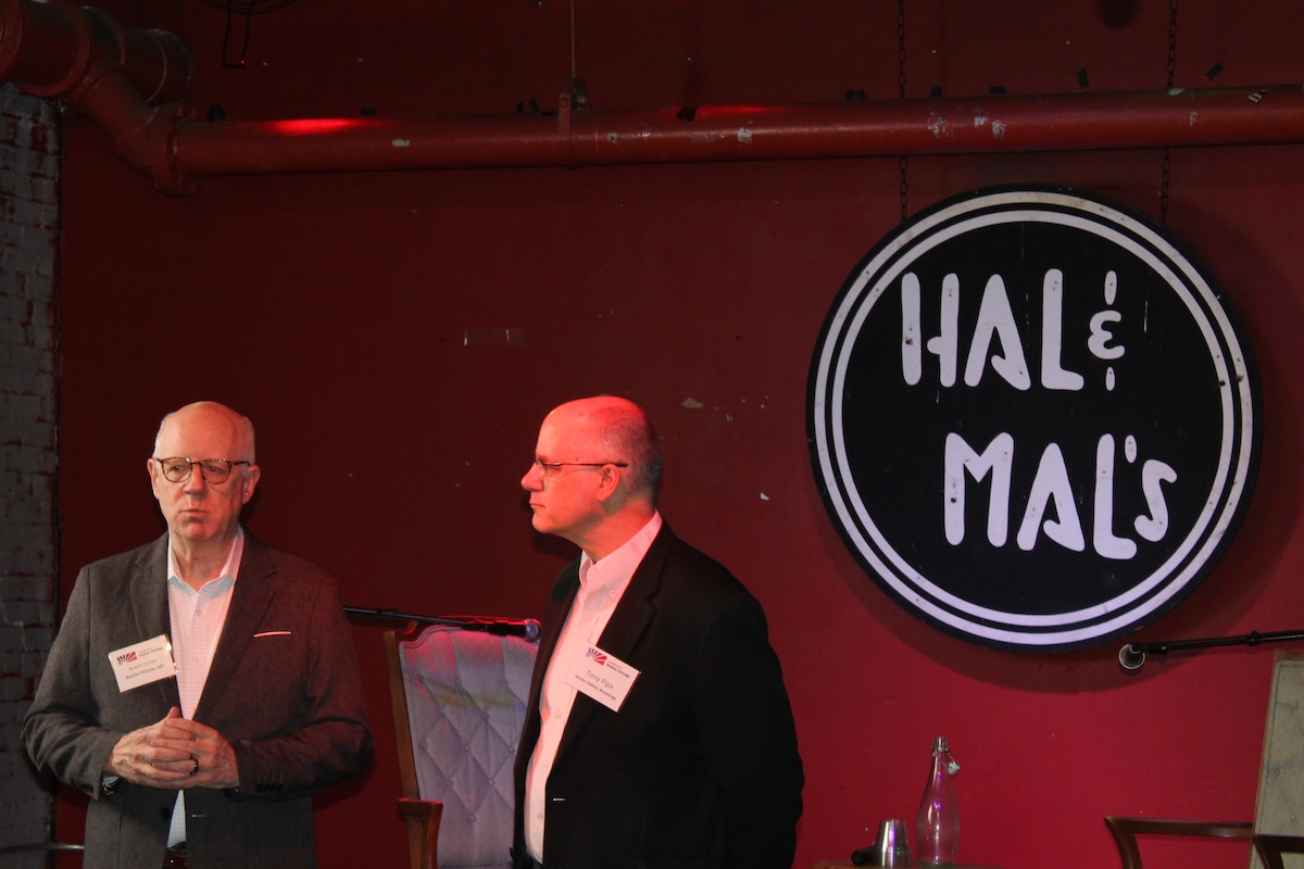 Brookings Senior Fellow Brent Orrell and Tony Pipa standing together at an evening reception at Hal & Mal's in Jackson, Mississippi.