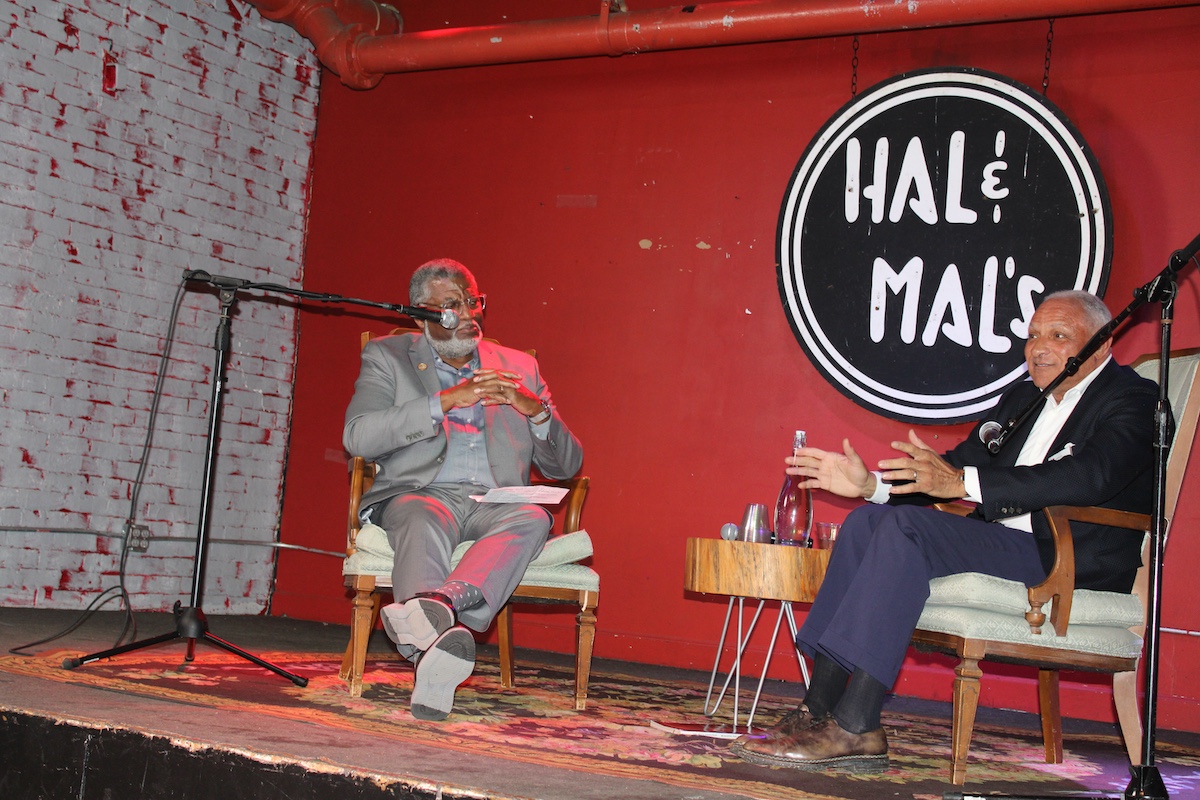 Commission Member Bill Bynum and former U.S. Secretary of Agriculture Mike Espy seated in conversation during a fireside chat in Jackson, Mississippi.