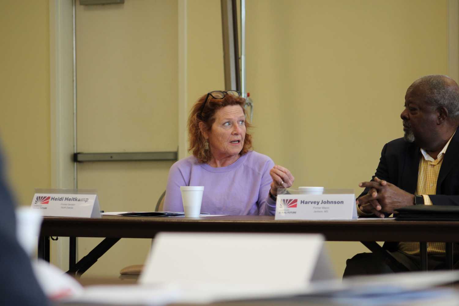 Commission Co-Chair Heidi Heitkamp speaking with former Jackson Mayor Harvey Johnson during a panel discussion in Yazoo City, Mississippi.