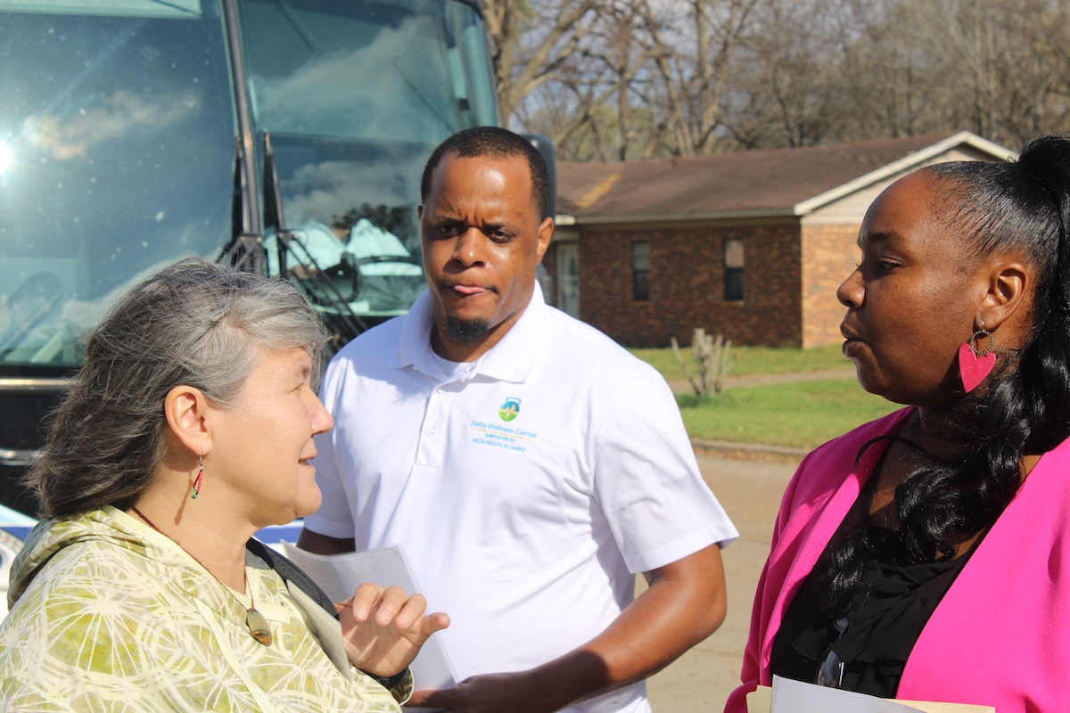 Commission Member Val Davidson speaking with a clinic staff member about primary care access and community health efforts in the Mississippi Delta.
