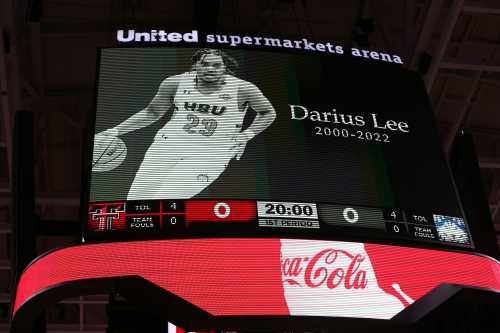 An arena billboard honoring basketball player Darius Lee