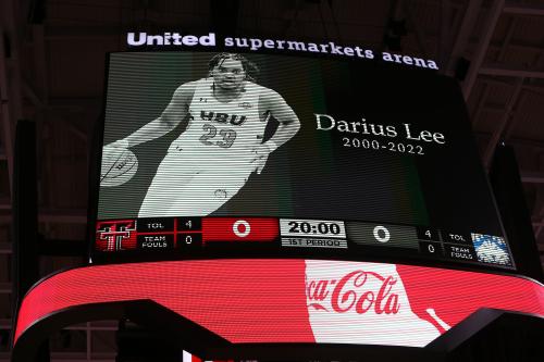 An arena billboard honoring basketball player Darius Lee