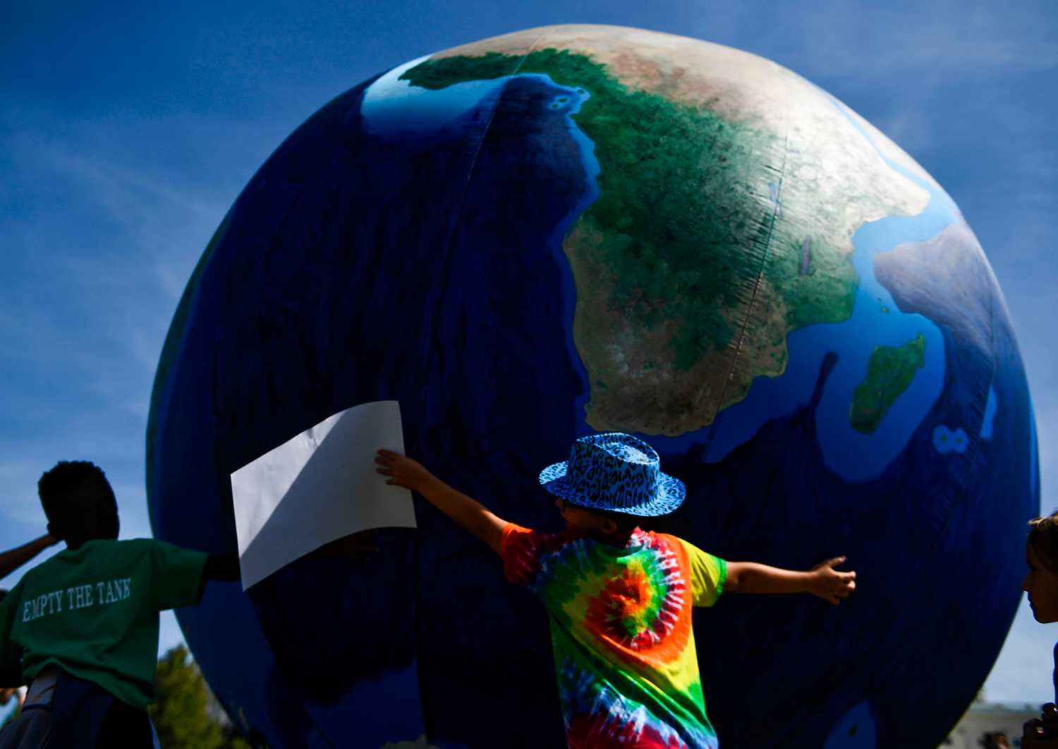 TOPSHOT - Students and activists hold up a globe near the US Capitol during the Global Climate Strike march in Washington, DC on September 20, 2019. - Crowds of children skipped school to join a global strike against climate change, heeding the rallying cry of teen activist Greta Thunberg and demanding adults act to stop environmental disaster. It was expected to be the biggest protest ever against the threat posed to the planet by climate change. (Photo by Brendan Smialowski / AFP) (Photo credit should read BRENDAN SMIALOWSKI/AFP via Getty Images)
