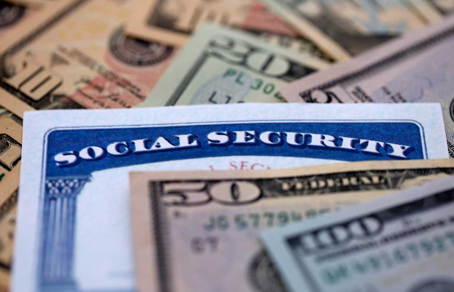 A Social Security card in a pile of money.