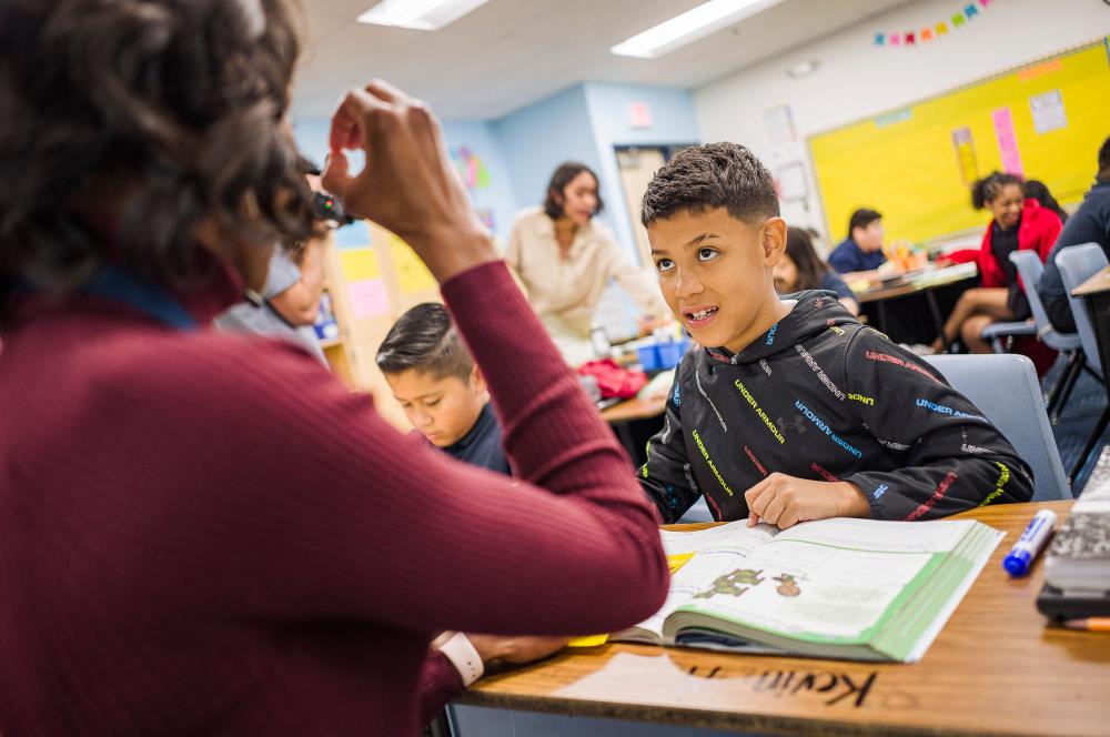 Teacher with student in a classroom