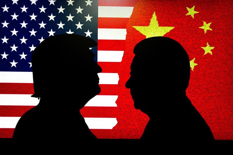 Illustration showing profiles of U.S. President Donald Trump and China President Xi Jinping in front of their countries' respective flags