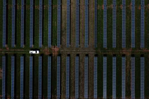 This aerial image shows a vehicle driving through a solar farm, which produces energy that could power nearly half the town, on former US President Jimmy Carter's land in Plains, Georgia, on February 22, 2023. - Jimmy Carter, the 98-year-old former US president who led the nation from 1977 to 1981, is receiving hospice care at home, where he will spend his "remaining time," his nonprofit foundation said on February 18, 2023. (Photo by Brendan Smialowski / AFP) (Photo by BRENDAN SMIALOWSKI/AFP via Getty Images)