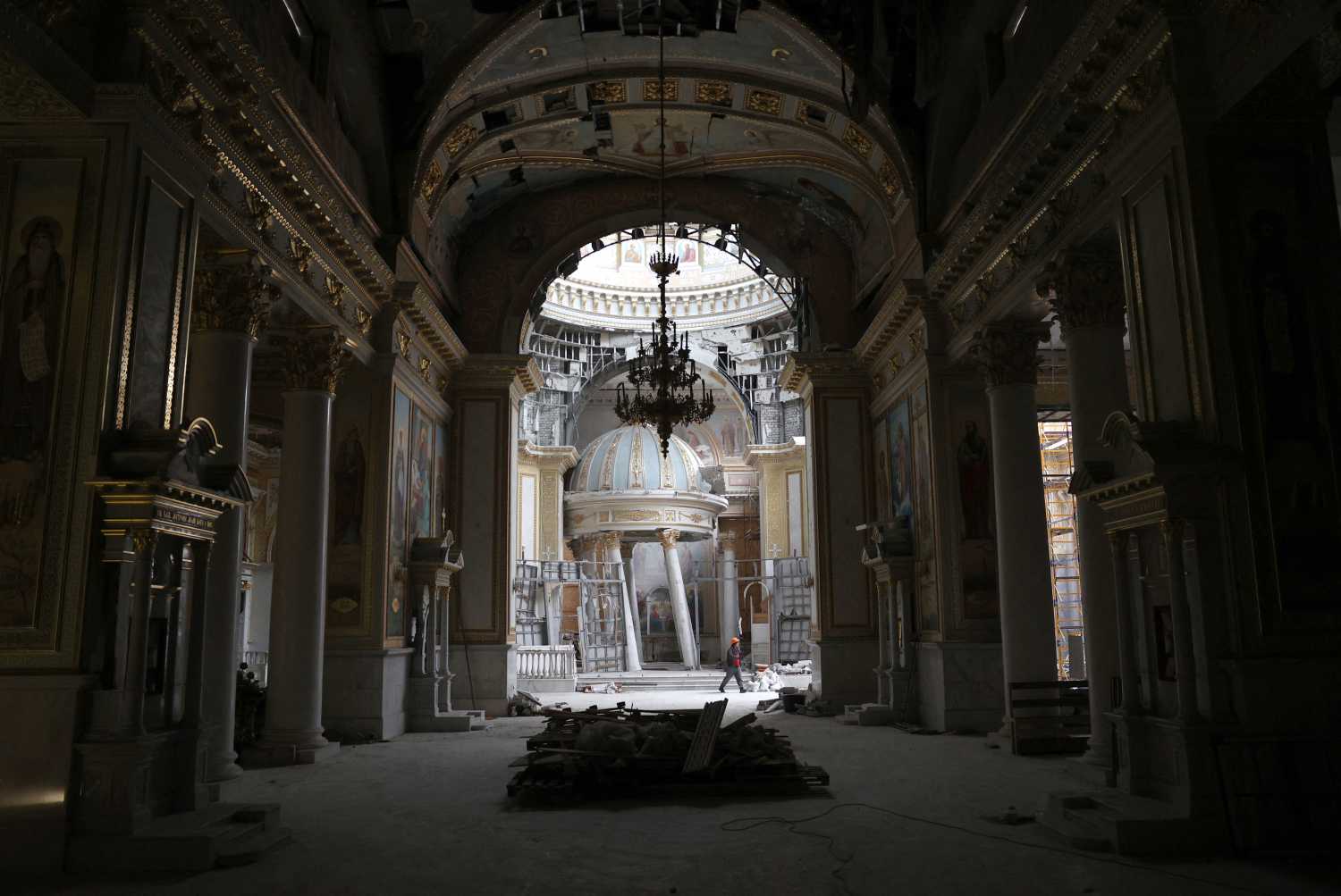 A worker repairs the Cathedral of the Transfiguration damaged as a result of Russian missile strike on July 23, 2023, in Odessa on December 18, 2023, amid Russian invasion in Ukraine.