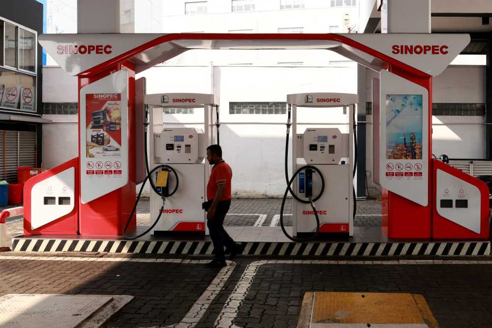 An employee waits for a customer at Sinopec fuel station on February 05, 2025 in Colombo, Sri Lanka.