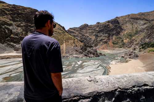 A man views the low water inlet of the river upstream of the Amir Kabir dam along the Karaj river in Iran's northern Alborz mountain range on June 1, 2025.