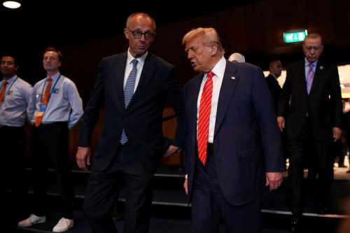 U.S. President Donald Trump (R) speaks to German Chancellor Friedrich Merz (L) on the second day of the 2025 NATO Summit on June 25, 2025 in The Hague, Netherlands.