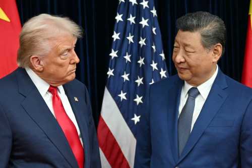US President Donald Trump (L) and China's President Xi Jinping greet each other as they arrive for talks at the Gimhae Air Base, located next to the Gimhae International Airport in Busan on October 30, 2025.