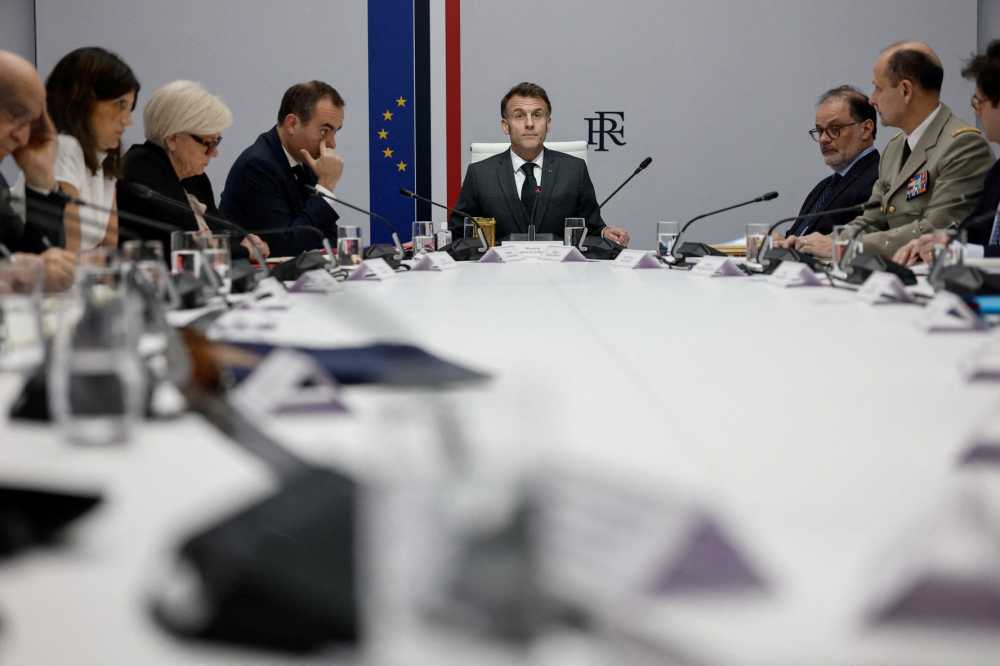 France's President Emmanuel Macron (C) speaks next to France's Prime Minister Sebastien Lecornu (4L) and France's Defence Minister Catherine Vautrin (3L) during a national defence council meeting on Middle East war at the Elysee Palace in Paris on March 17, 2026.