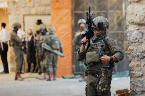 An armed Israeli soldier stands guard in the Old City of Hebron, the occupied West Bank, on May 16, 2026.
