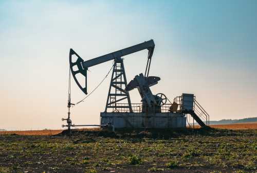An oil derrick in the countryside.