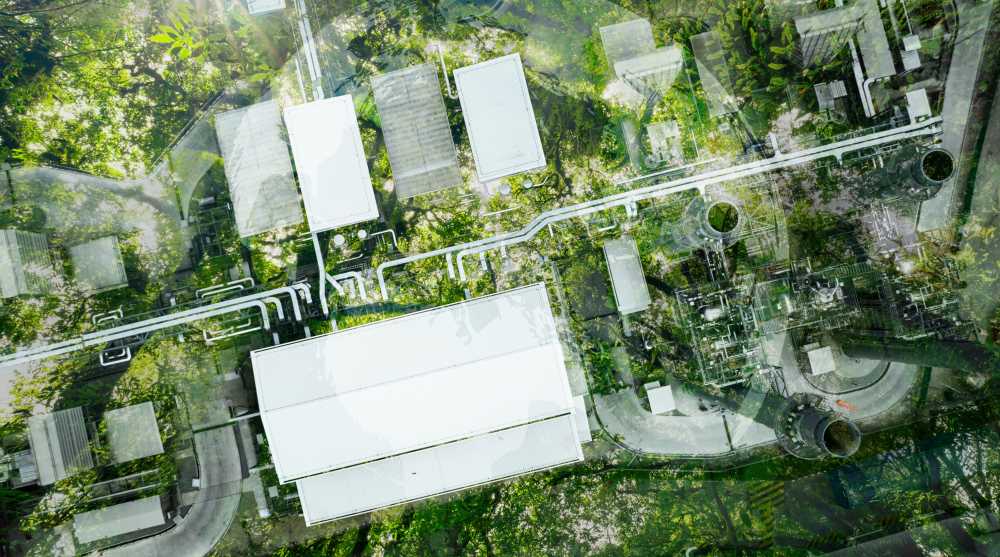 Aerial view of forest canopy with digital overlay of factory roofs