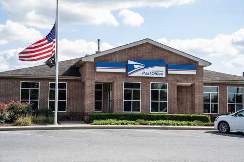 Wernersville, Pennsylvania, USA, October 2, 2020: Flag at half staff at United States Post Office building.