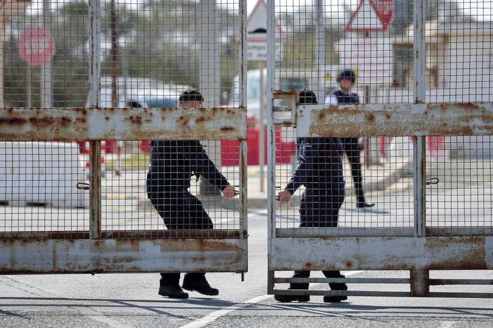 People operate the gate at RAF Akrotiri, a British sovereign base that was hit by a drone early on Monday, causing limited damage, after sirens sounded, in Cyprus, March 6, 2026.