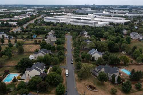 ASHBURN, VIRGINIA - JULY 17: In an aerial view, various data centers are shown situated near a neighborhood on July 17, 2024, in Ashburn, Virginia. Northern Virginia is the largest data center market in the world, according to a report this year cited in published accounts, but is facing headwinds from availability of land and electric power.