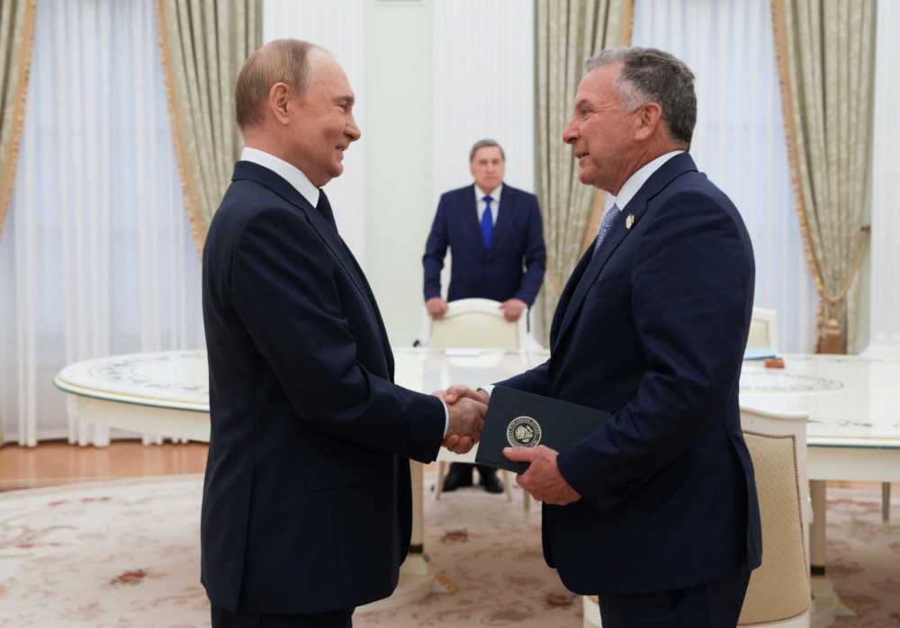 In this pool photograph distributed by the Russian state agency Sputnik, Russia's President Vladimir Putin greets US Special Envoy Steve Witkoff prior to their talks in Moscow on August 6, 2025.