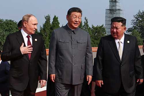 In this pool photograph distributed by the Russian state agency Sputnik, (L-R) Russia's President Vladimir Putin walks with China's President Xi Jinping and North Korea's leader Kim Jong Un before a military parade marking the 80th anniversary of victory over Japan and the end of World War II, in Beijing's Tiananmen Square on September 3, 2025.
