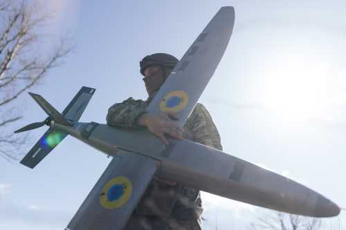 A portrait of a soldier from the "Taifun" unmanned aerial vehicle unit holding a new model 'Marsianin' attack drone on April 7, 2026 in Kharkiv region, Ukraine.