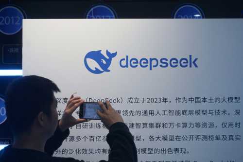 A man takes photos of a DeepSeek display at a shopping mall in Hangzhou, in China's eastern Zhejiang province