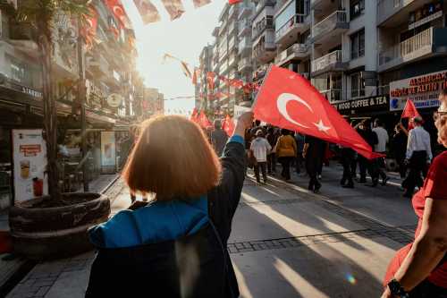 A demonstrator waves a Turkish flag during a protest in Izmir, Turkey, on May 24, 2026.