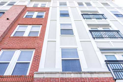 New construction exterior pattern of apartment condo, condominiums residential windows with brick colorful colors, modern siding in Virginia