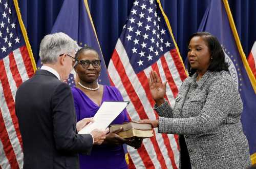 Lisa Cook (R) takes the oath of office as she is sworn in to become a member of the Federal Reserve Board by Federal Reserve Board Chair Jerome Powell, at the Federal Reserve Building in Washington, D.C., on May 23, 2022.