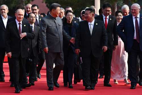 In this pool photograph distributed by the Russian state agency Sputnik, (front row L-R) Russia's President Vladimir Putin walks alongside China's President Xi Jinping, North Korea's leader Kim Jong Un and Belarus' President Alexander Lukashenko before a military parade marking the 80th anniversary of victory over Japan and the end of World War II, in Beijing's Tiananmen Square on September 3, 2025.