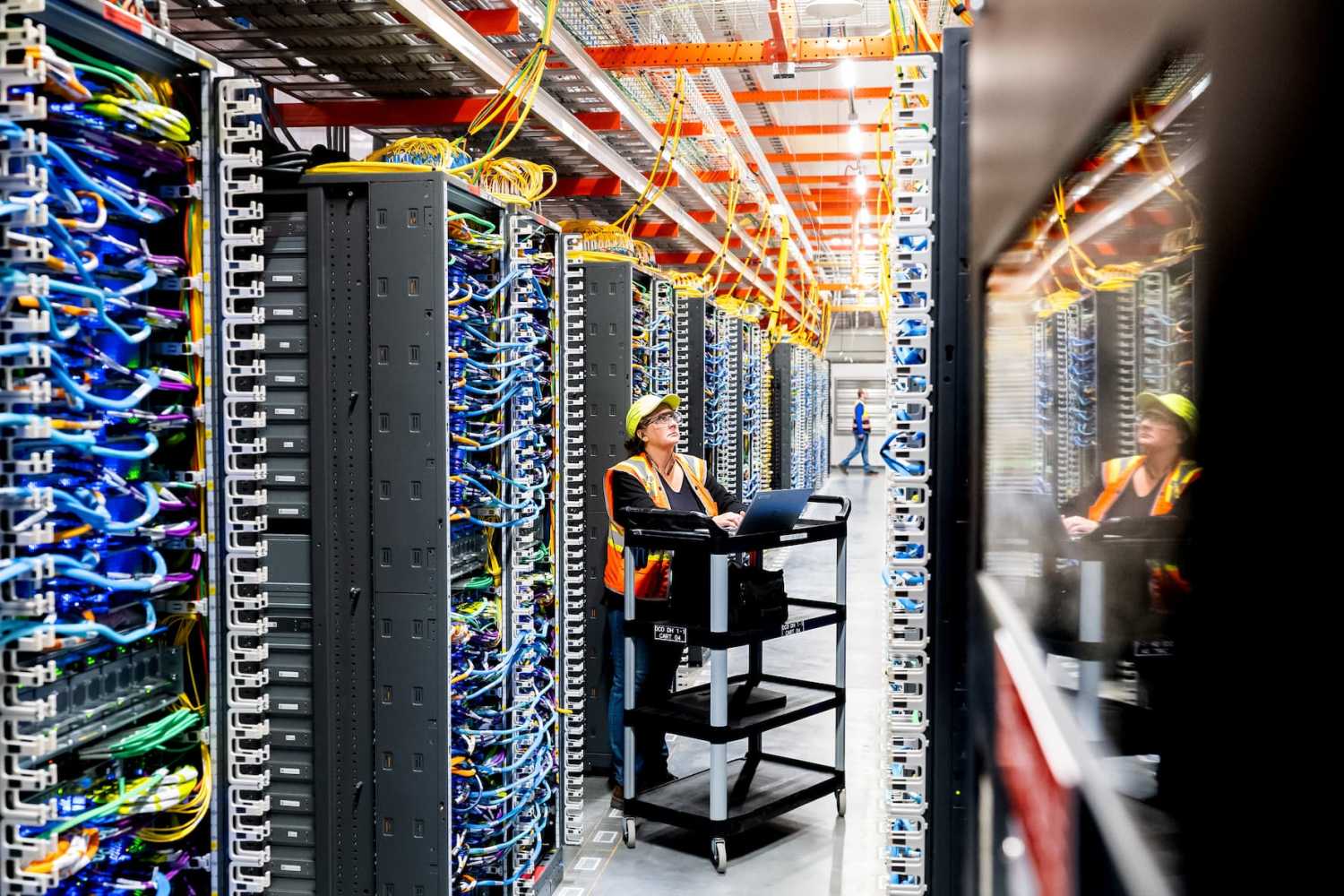 NEW CARLISLE, INDIANA - OCTOBER 2: In this handout provided by Amazon, a technician works at an Amazon Web Services AI data center in New Carlisle, Indiana on October 2, 2025.