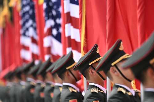 Chinese People's Liberation Army (PLA) honour guard stand with flags of the US and China in front of the Great Hall of the People ahead of a welcome ceremony for US President Donald Trump in Beijing on May 14, 2026.